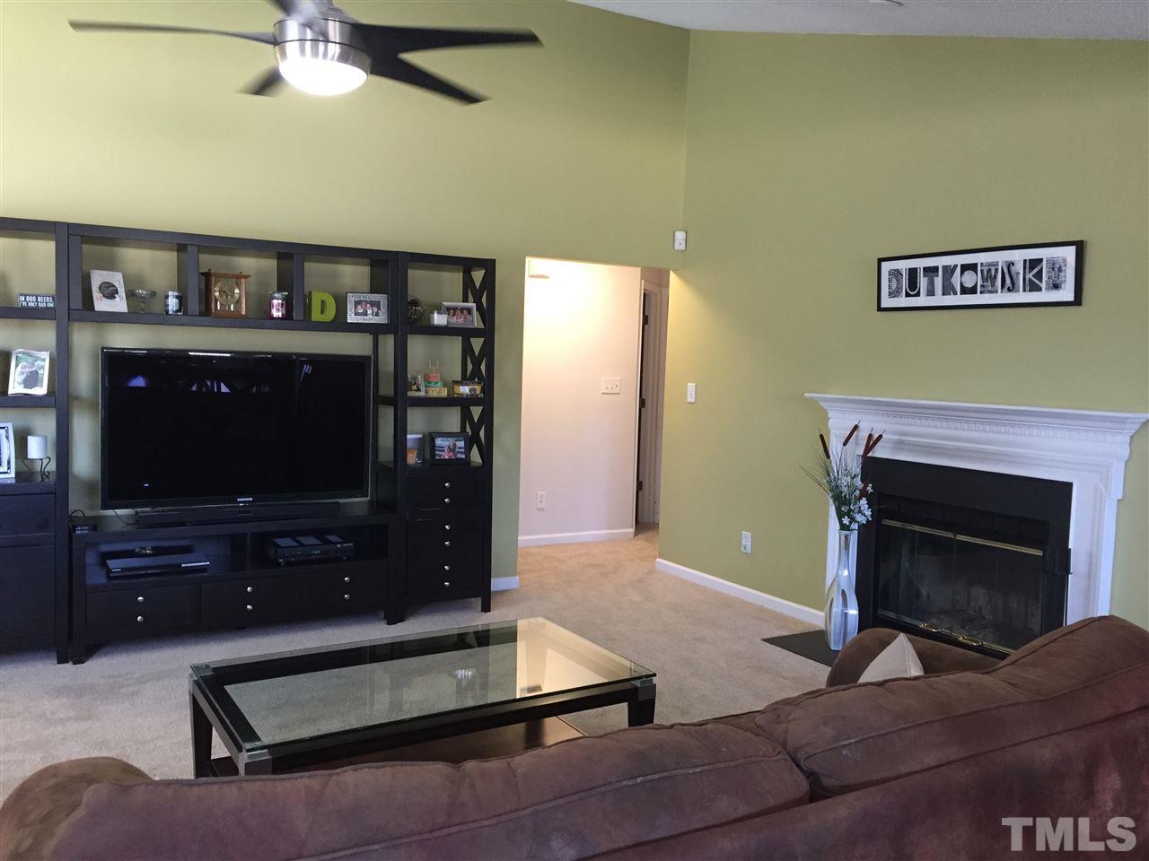 3613 Deering Drive Raleigh, NC 27616 - Photo 6 of 20 a living room with furniture a flat screen tv and a fireplace