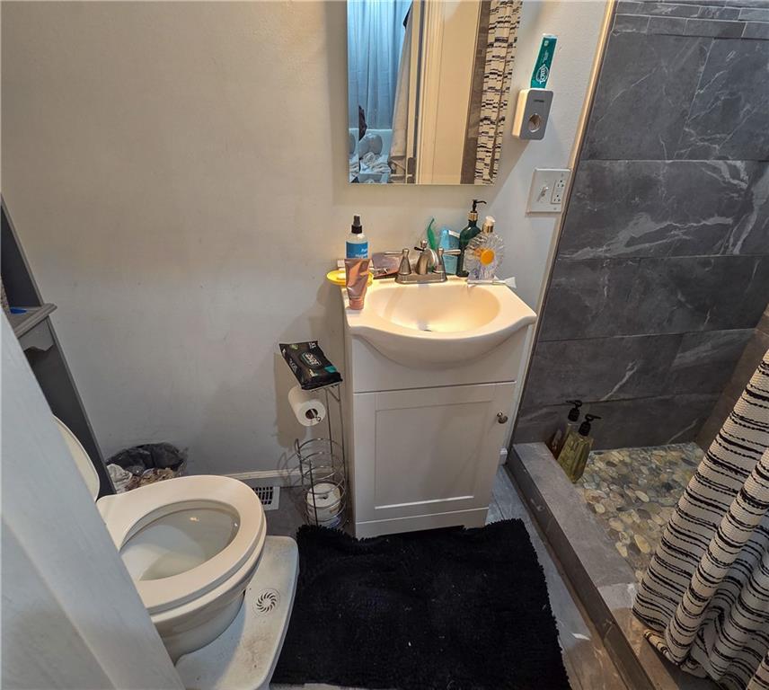 1809 Rialto Street Pittsburgh, PA 15212 - Photo 22 of 36 a bathroom with a sink toilet and a mirror