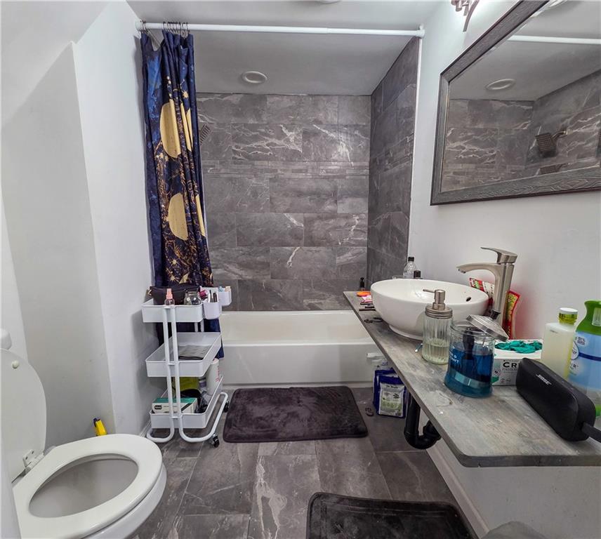 1809 Rialto Street Pittsburgh, PA 15212 - Photo 26 of 36 a bathroom with a sink a toilet and bathtub