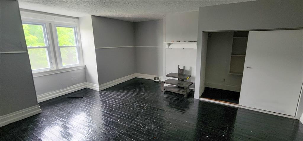 1809 Rialto Street Pittsburgh, PA 15212 - Photo 35 of 36 an empty room with wooden floor and windows