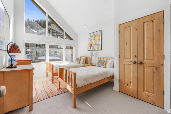 9927 Powder Run Road, Unit 10B Alta, UT 84092 - Photo 17 of 31 Bedroom with high vaulted ceiling and ensuite bath