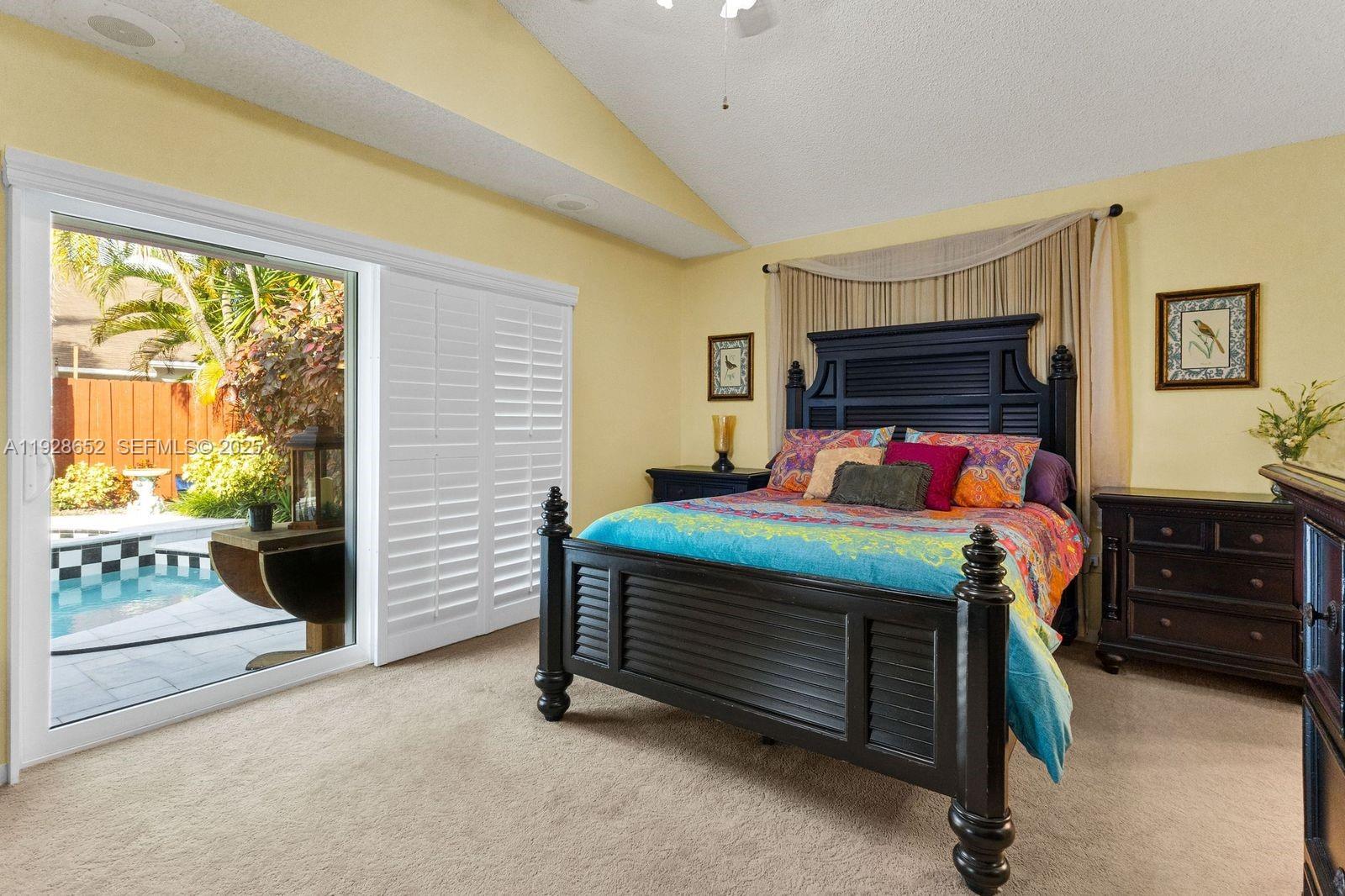 9871 Southwest 58th Court Cooper City, FL 33328 - Photo 11 of 54 a bedroom with a bed and a window