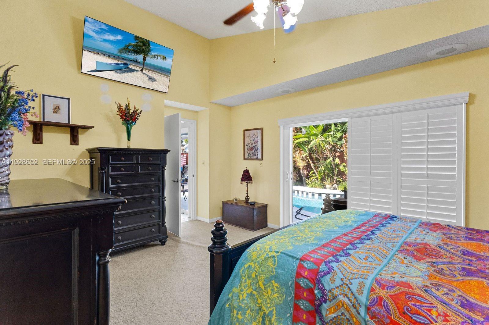 9871 Southwest 58th Court Cooper City, FL 33328 - Photo 12 of 54 a bedroom with a bed and furniture