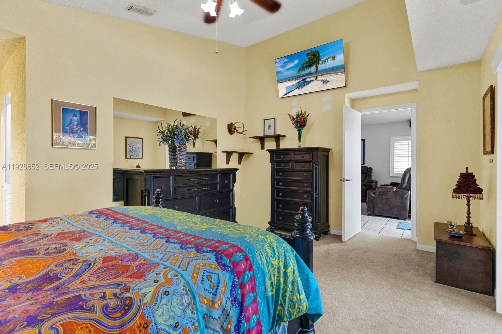 9871 Southwest 58th Court Cooper City, FL 33328 - Photo 13 of 54 a bedroom with a bed and a dresser