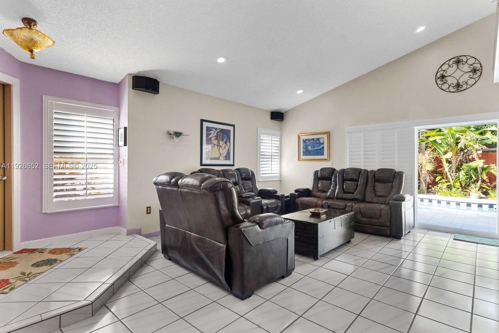 9871 Southwest 58th Court Cooper City, FL 33328 - Photo 16 of 54 a living room with furniture and a window