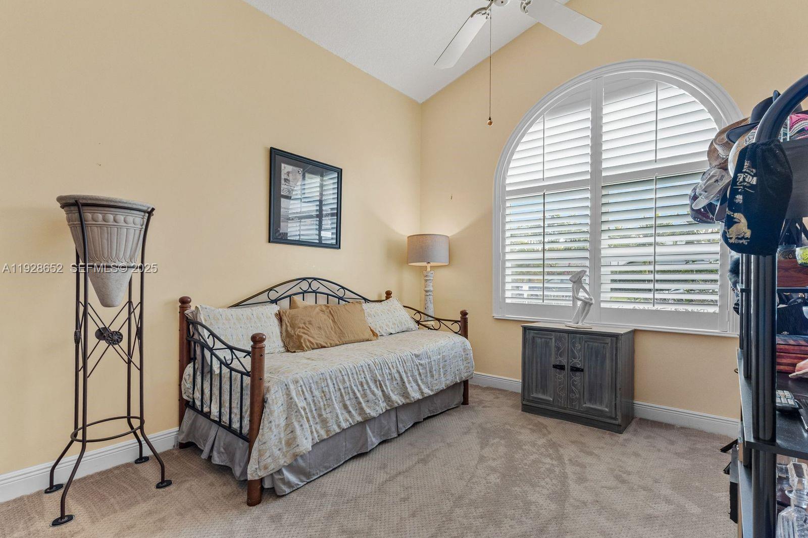 9871 Southwest 58th Court Cooper City, FL 33328 - Photo 27 of 54 a bedroom with a bed and a table