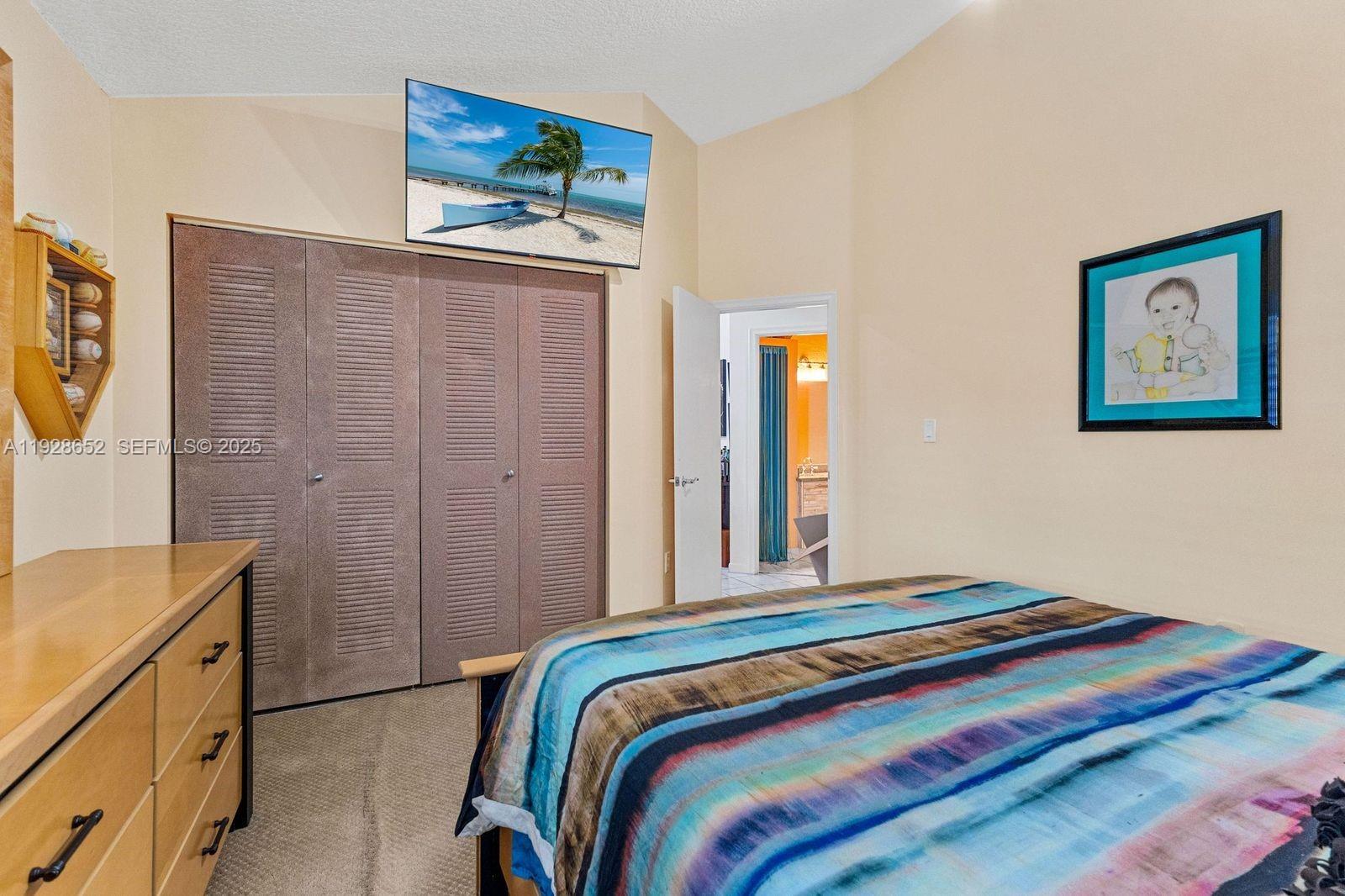 9871 Southwest 58th Court Cooper City, FL 33328 - Photo 28 of 54 a bedroom with a bed and a cabinets