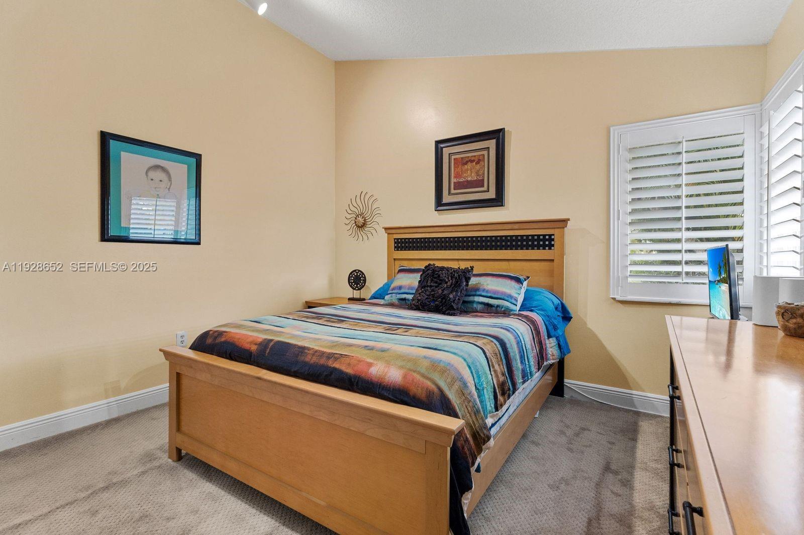 9871 Southwest 58th Court Cooper City, FL 33328 - Photo 29 of 54 a bedroom with bed and a window