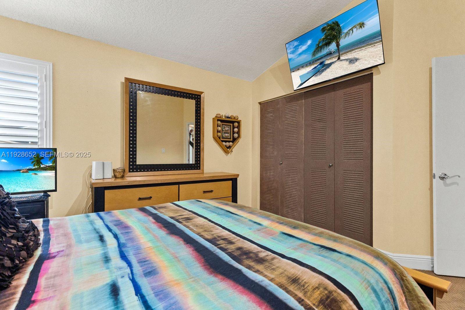 9871 Southwest 58th Court Cooper City, FL 33328 - Photo 30 of 54 a bedroom with a bed and a dresser