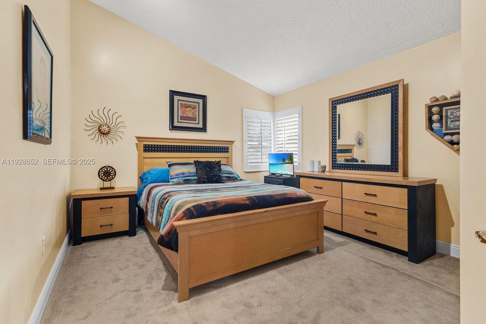 9871 Southwest 58th Court Cooper City, FL 33328 - Photo 31 of 54 a bedroom with a bed and a window