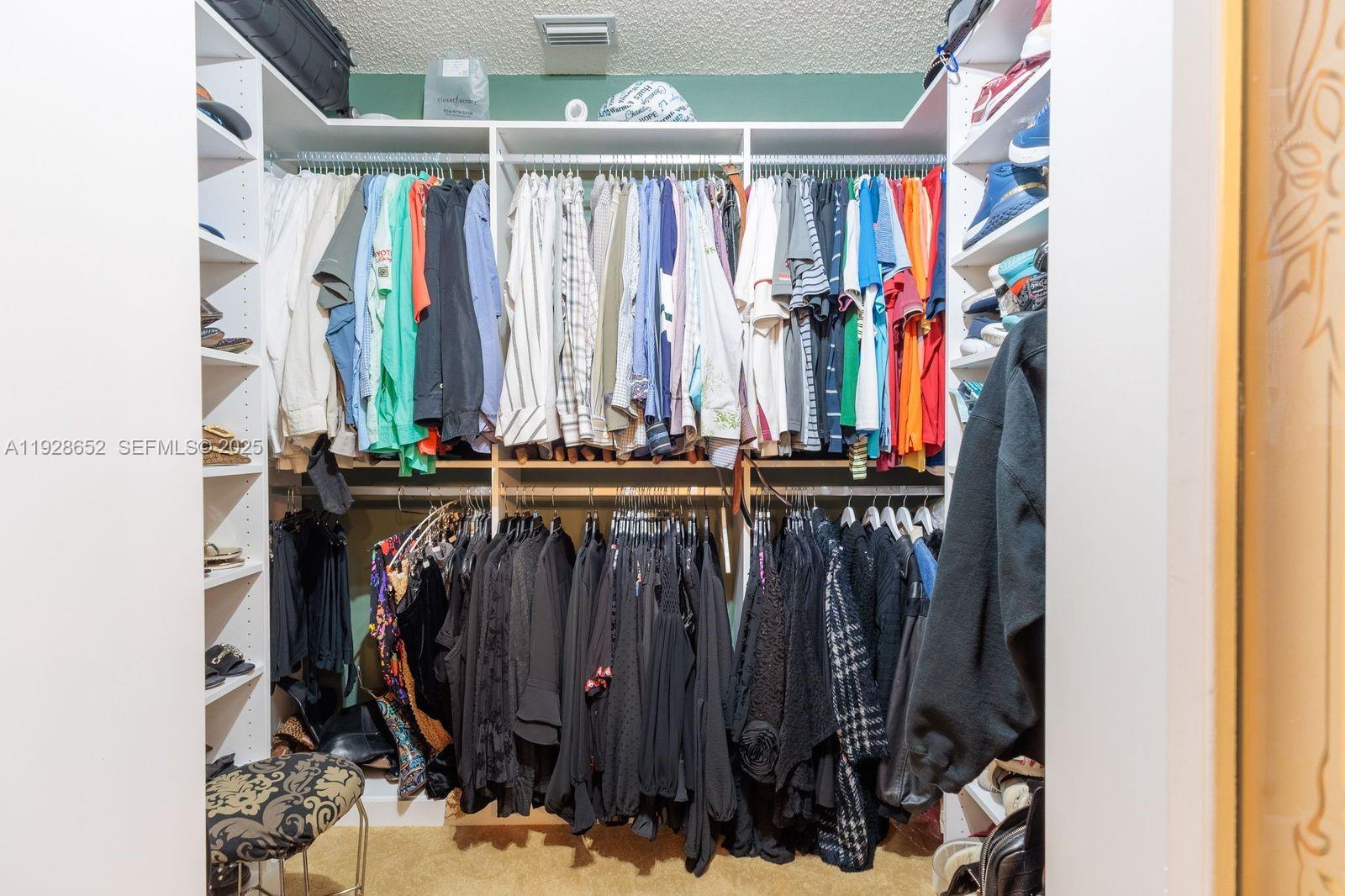 9871 Southwest 58th Court Cooper City, FL 33328 - Photo 33 of 54 a view of walk in closet with clothes