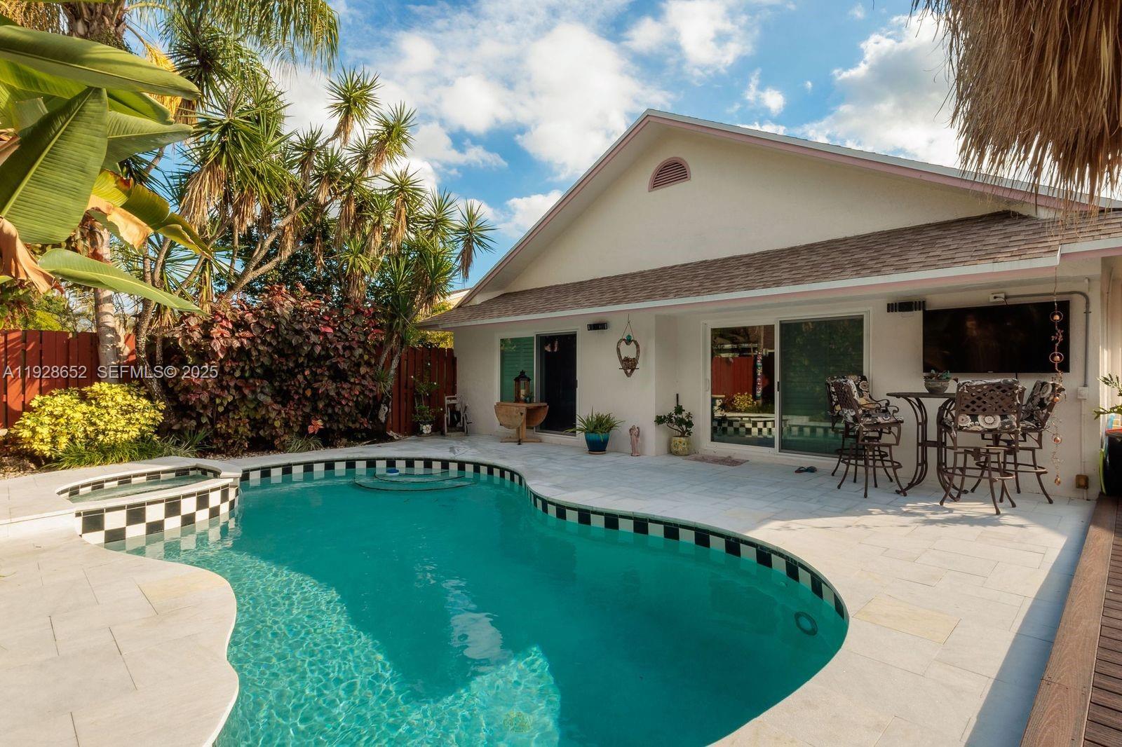 9871 Southwest 58th Court Cooper City, FL 33328 - Photo 4 of 54 a swimming pool with outdoor seating and yard