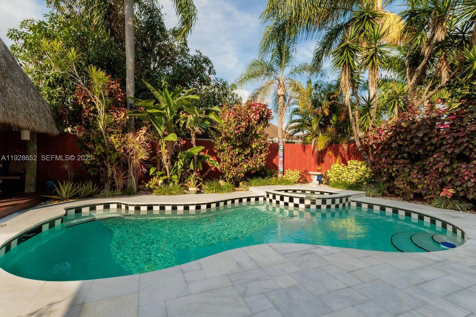 9871 Southwest 58th Court Cooper City, FL 33328 - Photo 5 of 54 a view of swimming pool with a garden