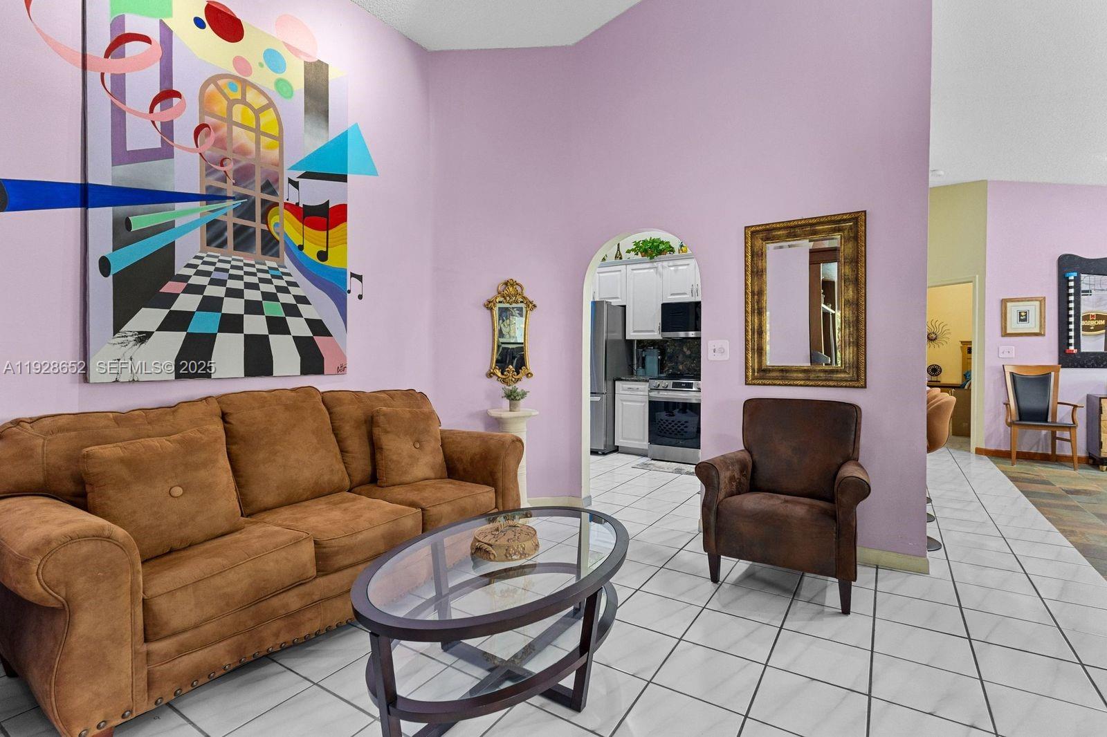 9871 Southwest 58th Court Cooper City, FL 33328 - Photo 7 of 54 a living room with furniture and a potted plant