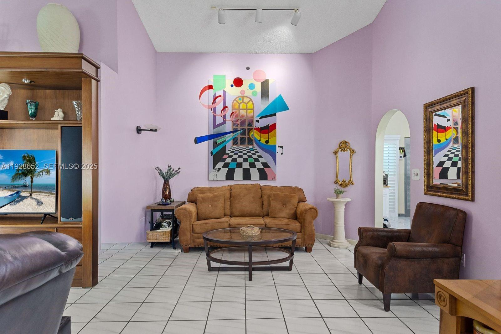9871 Southwest 58th Court Cooper City, FL 33328 - Photo 8 of 54 a living room with furniture and a couch