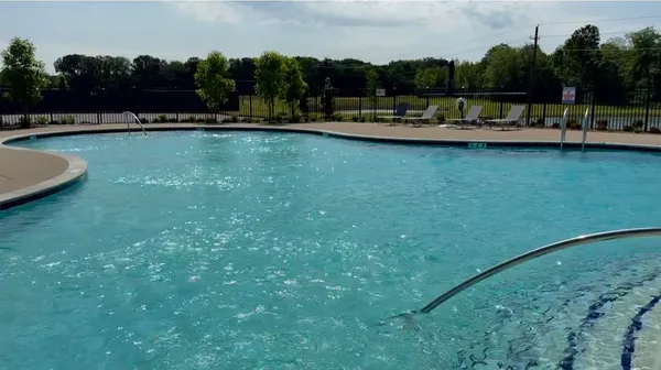 a view of a swimming pool and a yard