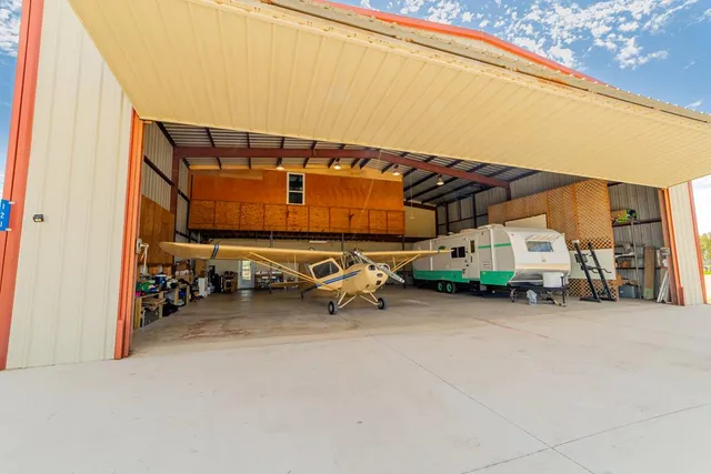 a view of a patio with table and chairs