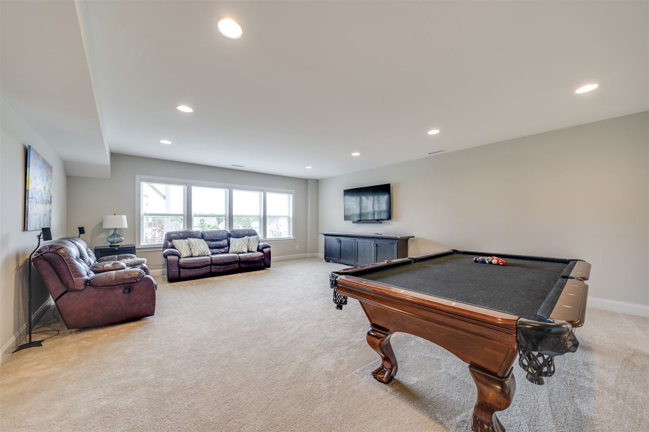 7504 Pinaster Place Raleigh, NC 27613 - Photo 24 of 30 Basement - This bonus room has a ton of natural light, recessed can lights, plush carpeting, and its own half bath! Bonus Room