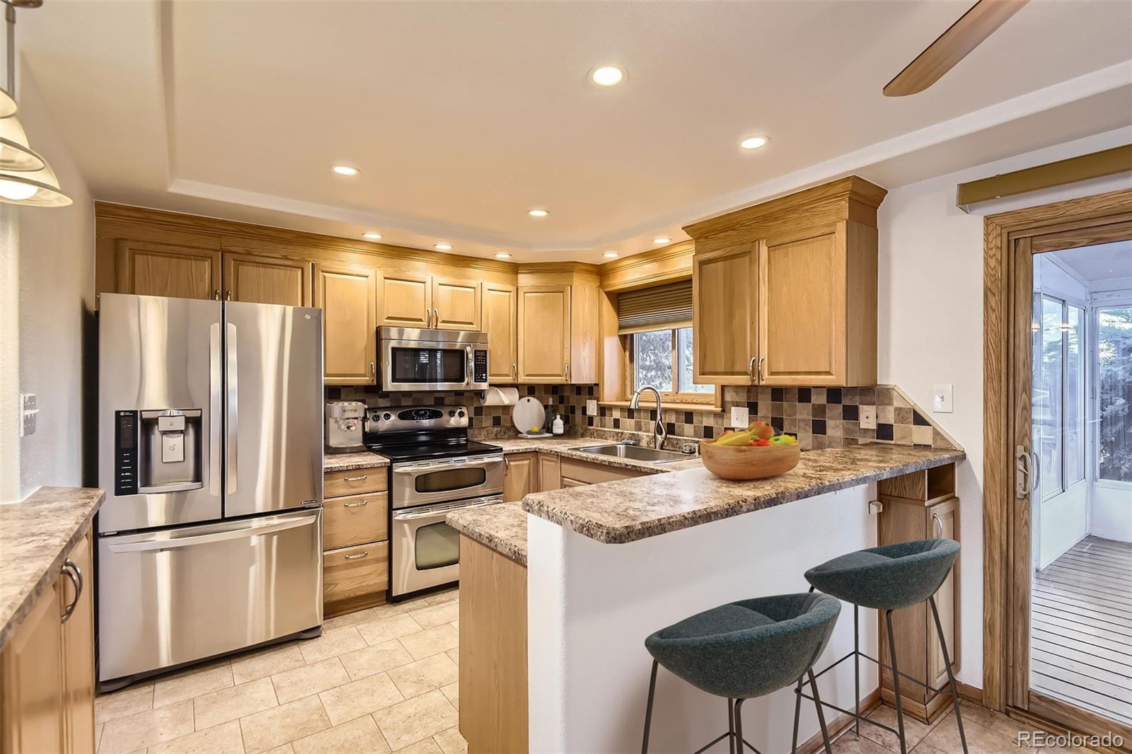 367 Jupiter Drive Lone Tree, CO 80124 - Photo 3 of 15 a kitchen with stainless steel appliances granite countertop a sink a stove a refrigerator and island