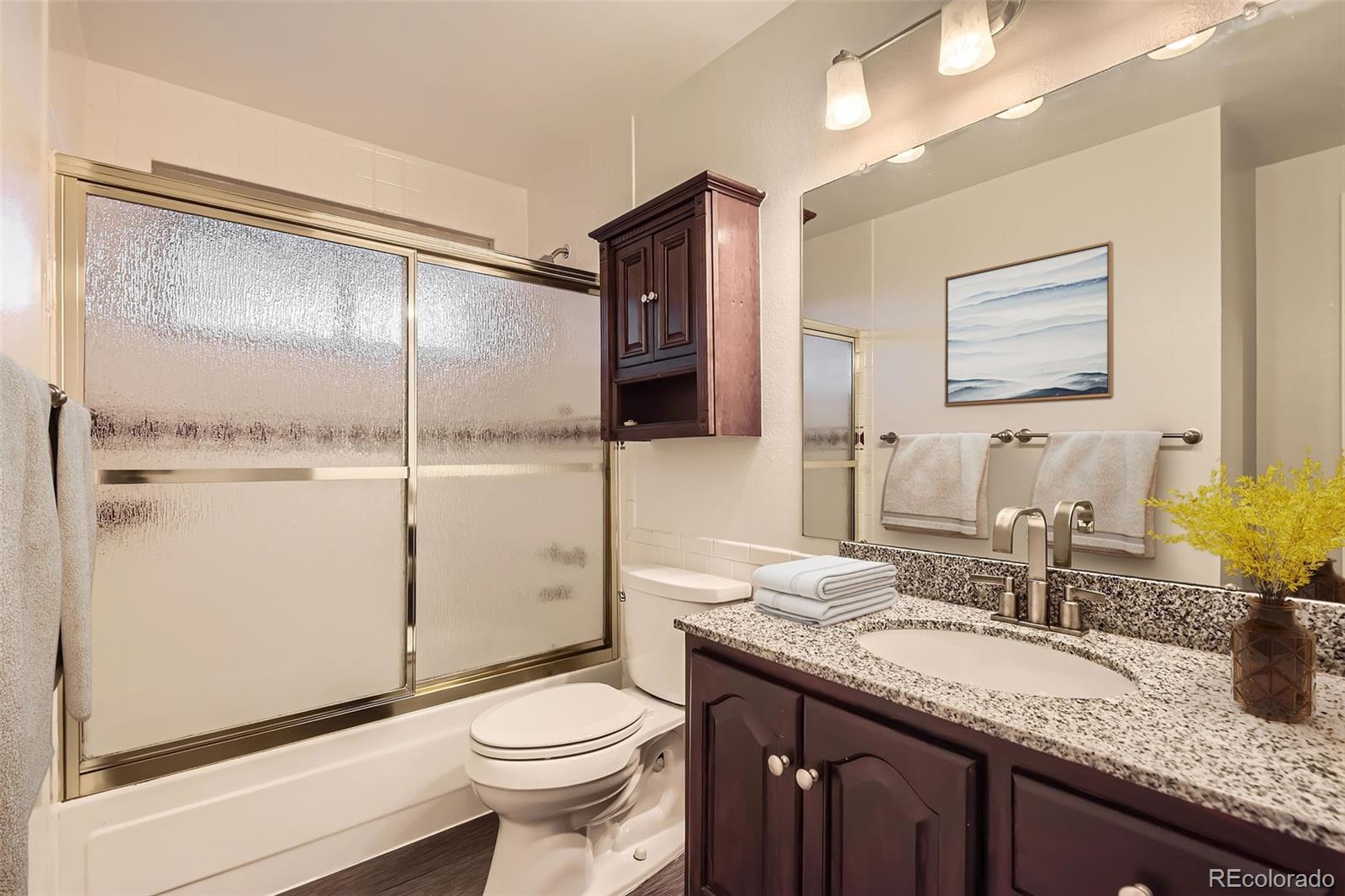 367 Jupiter Drive Lone Tree, CO 80124 - Photo 7 of 15 a bathroom with a granite countertop sink toilet and shower