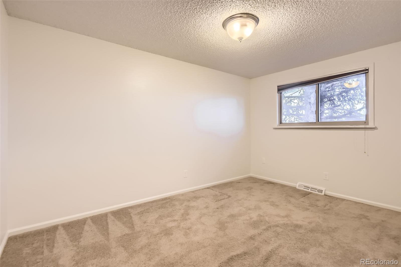 367 Jupiter Drive Lone Tree, CO 80124 - Photo 8 of 15 an empty room with a window