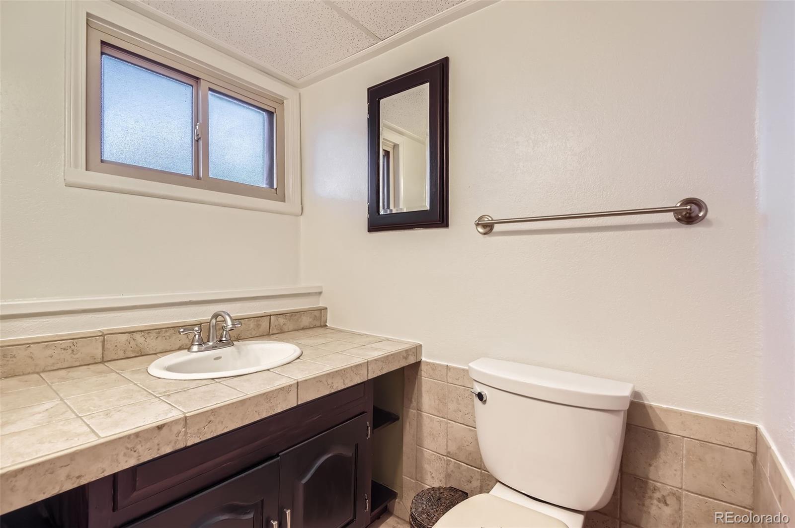 367 Jupiter Drive Lone Tree, CO 80124 - Photo 10 of 15 a bathroom with a toilet a sink and mirror