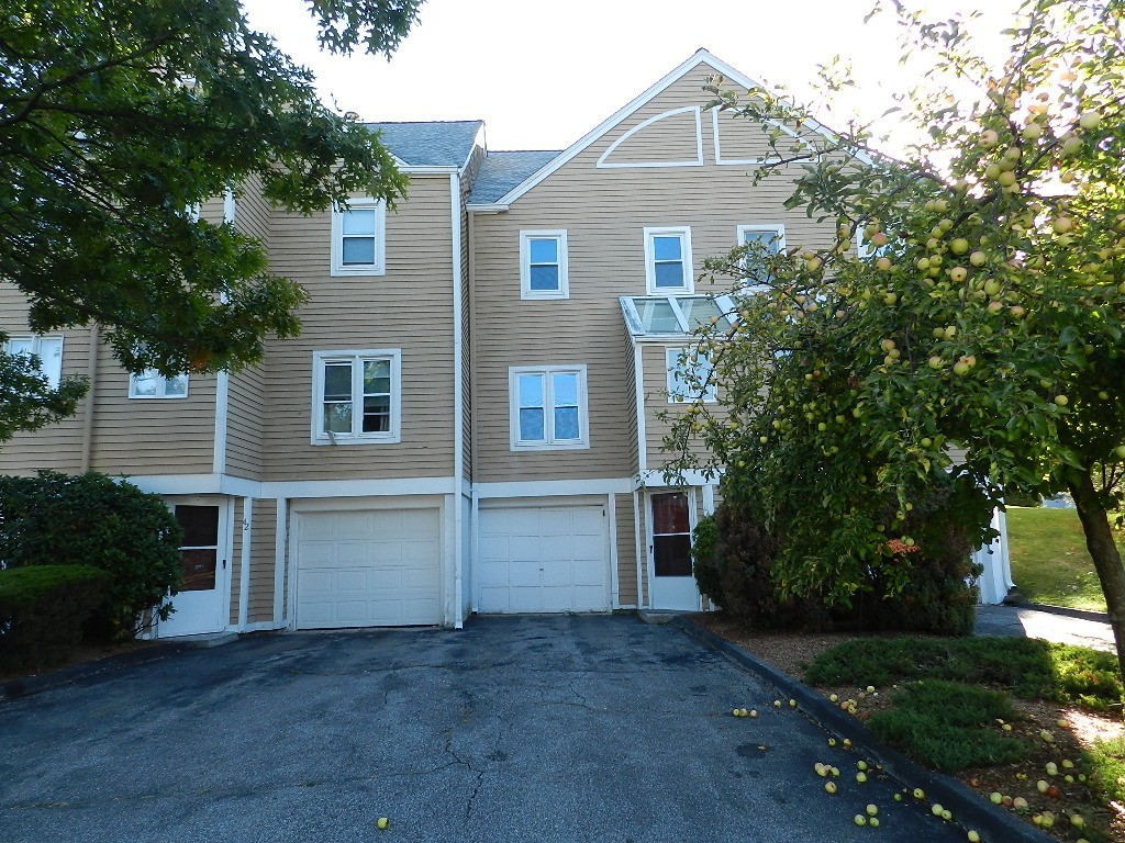 40 Wrentham Road, Unit 40 Worcester, MA 01602 - Photo 1 of 11 a front view of a house with a yard and garage