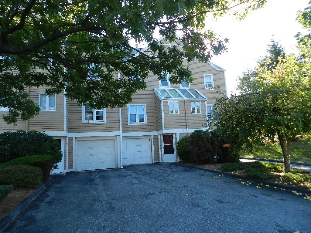 40 Wrentham Road, Unit 40 Worcester, MA 01602 - Photo 2 of 11 a front view of a house with a yard and garage