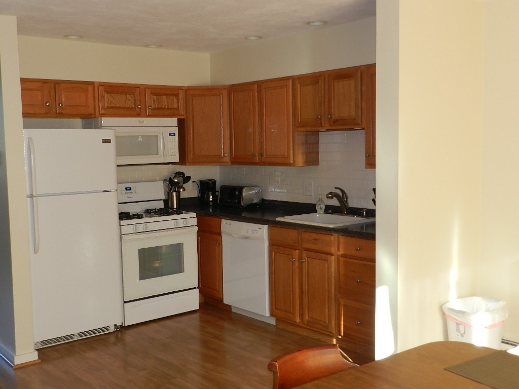 40 Wrentham Road, Unit 40 Worcester, MA 01602 - Photo 3 of 11 a kitchen with stainless steel appliances a refrigerator and cabinets