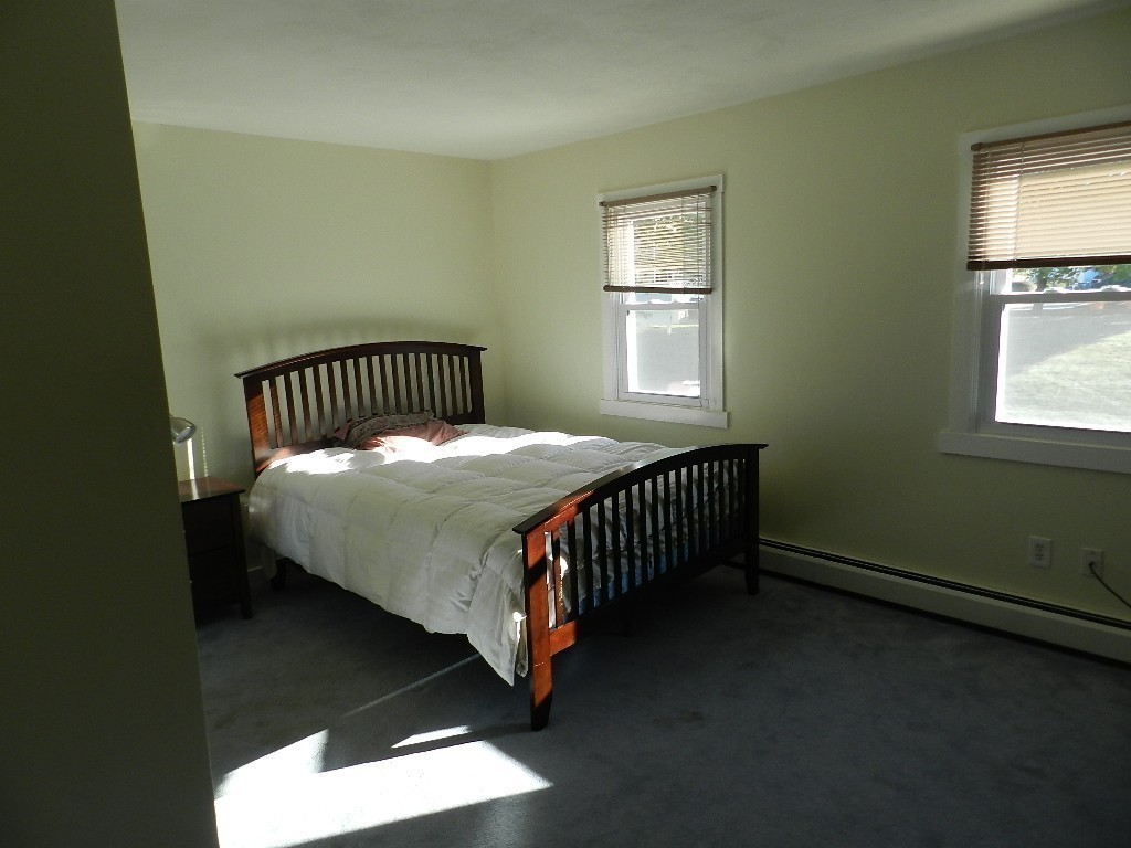 40 Wrentham Road, Unit 40 Worcester, MA 01602 - Photo 8 of 11 a bedroom with a bed and window