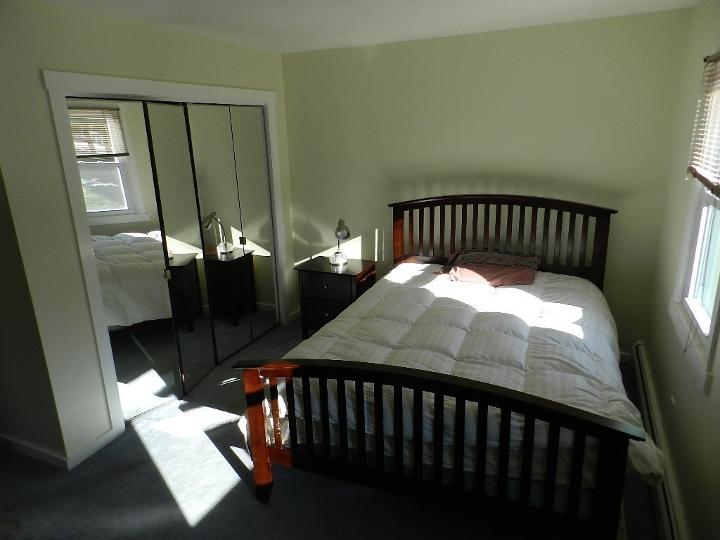 40 Wrentham Road, Unit 40 Worcester, MA 01602 - Photo 9 of 11 a bed sitting in a bedroom next to a window