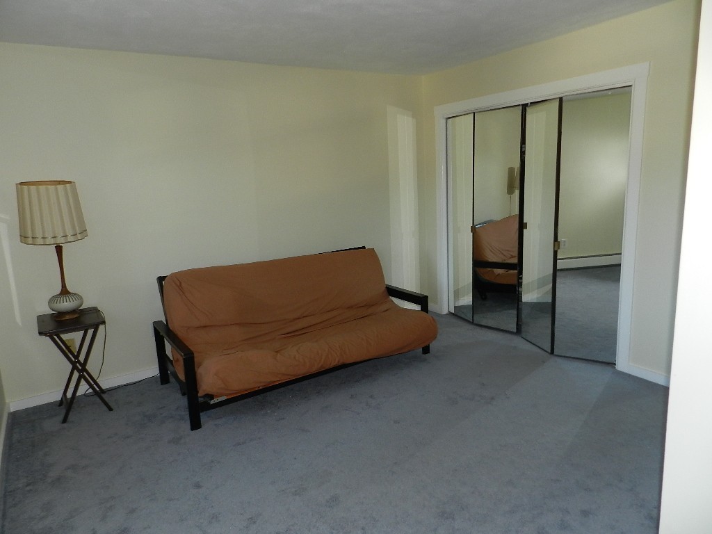 40 Wrentham Road, Unit 40 Worcester, MA 01602 - Photo 10 of 11 a bedroom with a bed and a lamp on table