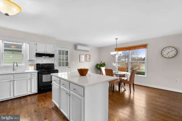 a kitchen with granite countertop a stove top oven sink and cabinets