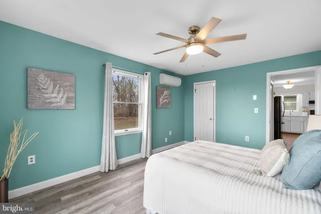a bedroom with a large bed and a chandelier