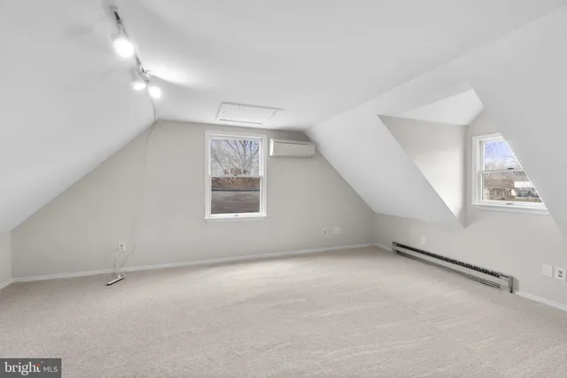 an empty room with a empty space and windows