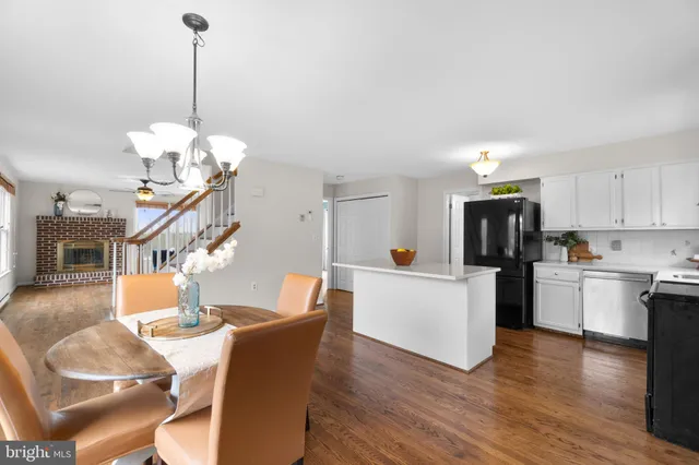 a living room with dining table furniture and a wooden floor