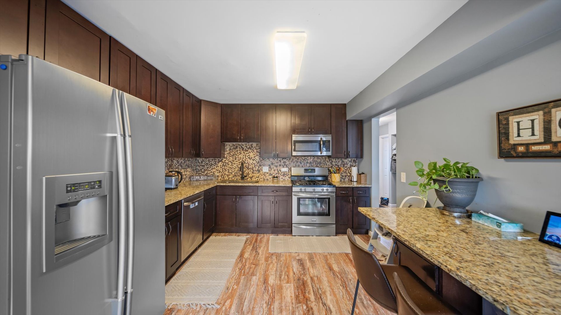 1005 Spring Mill Drive Hoffman Estates, IL 60169 - Photo 11 of 44 a kitchen with granite countertop stainless steel appliances and wooden cabinets