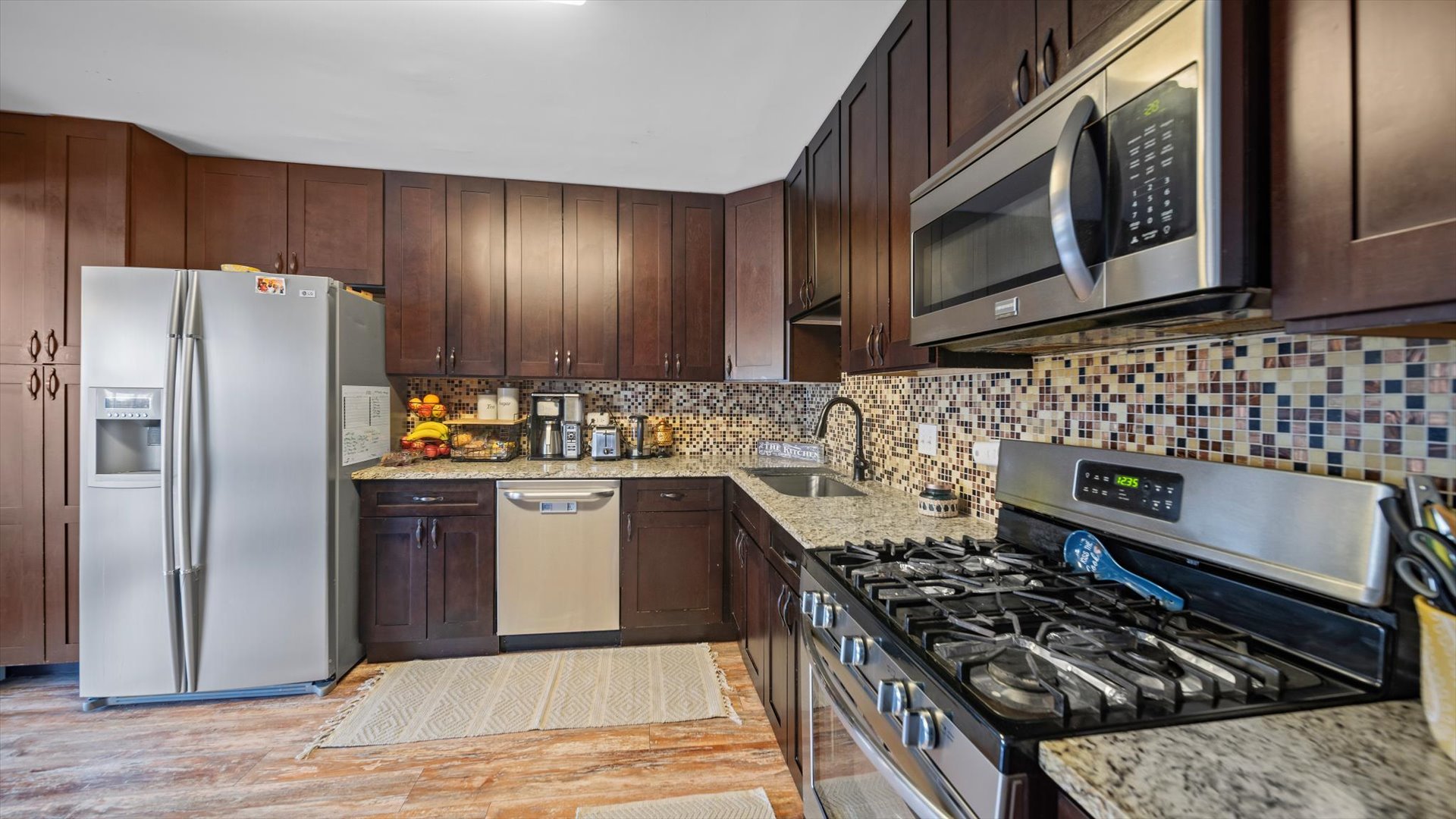 1005 Spring Mill Drive Hoffman Estates, IL 60169 - Photo 14 of 44 a kitchen with a stove and a refrigerator