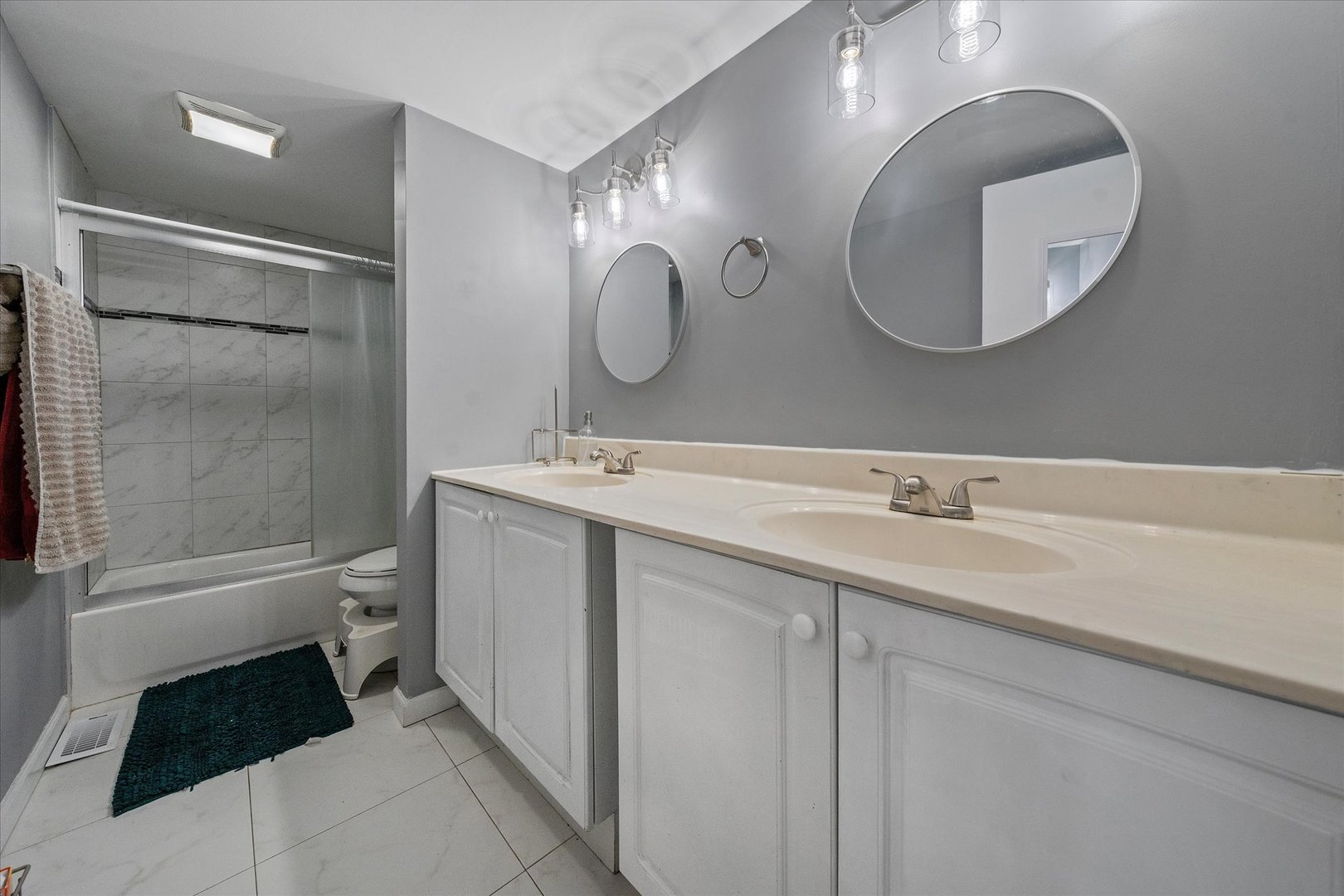 1005 Spring Mill Drive Hoffman Estates, IL 60169 - Photo 25 of 44 a bathroom with a double vanity sink mirror and toilet