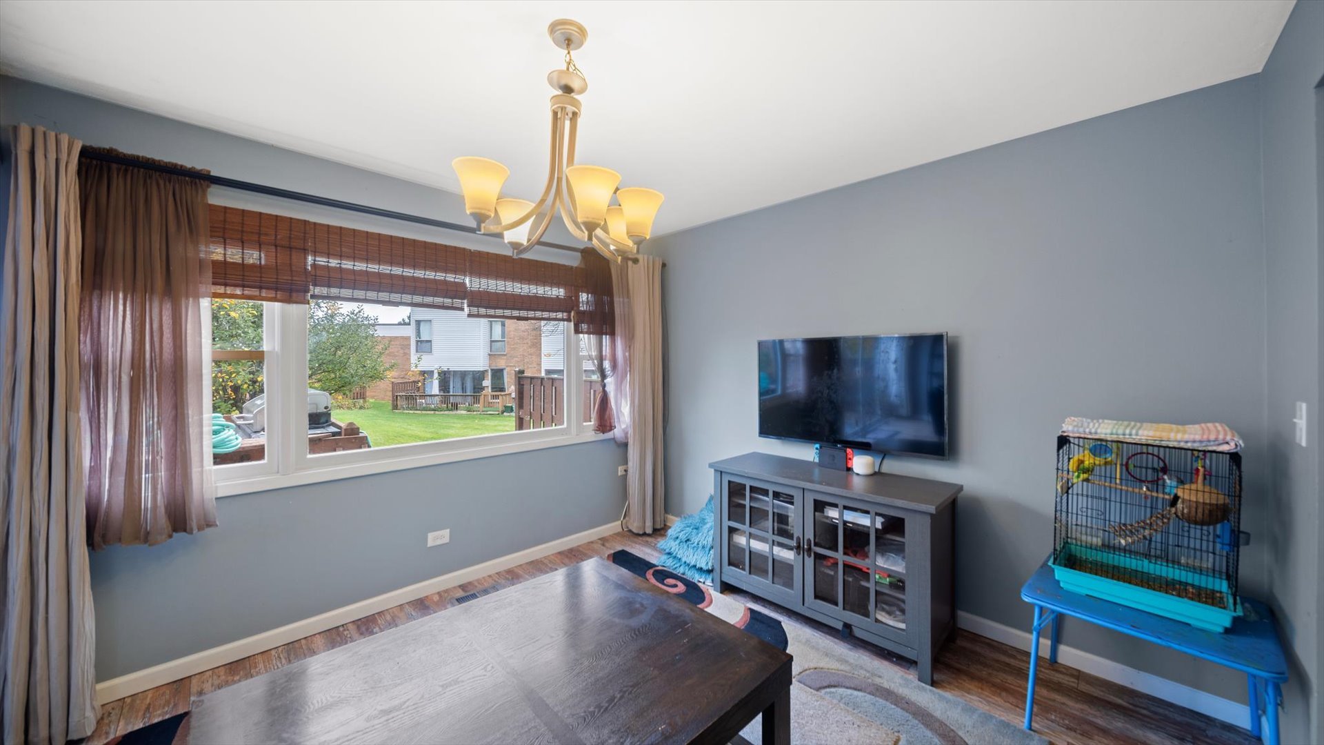 1005 Spring Mill Drive Hoffman Estates, IL 60169 - Photo 8 of 44 a living room with furniture and a flat screen tv