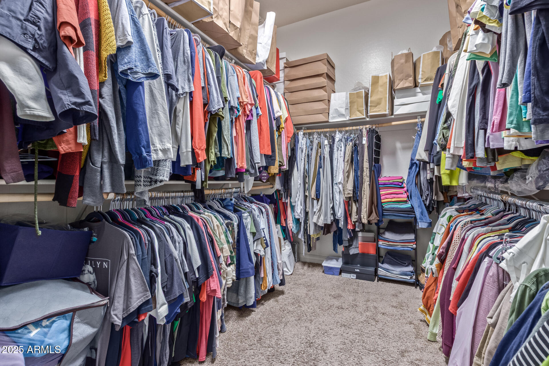 17743 West Verdin Road Goodyear, AZ 85338 - Photo 23 of 69 a view of walk in closet with clothes