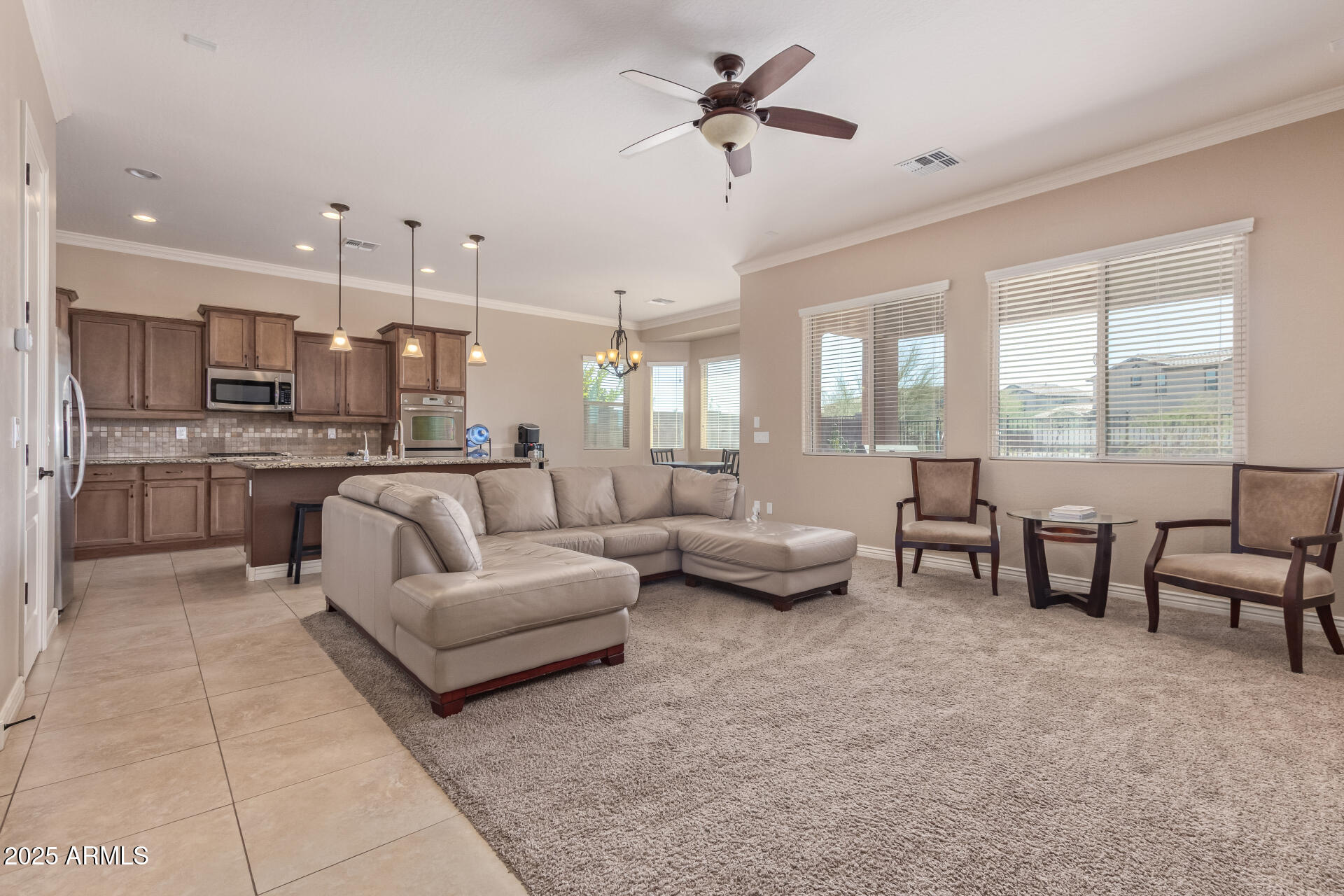 17743 West Verdin Road Goodyear, AZ 85338 - Photo 9 of 69 a living room with furniture and a large window