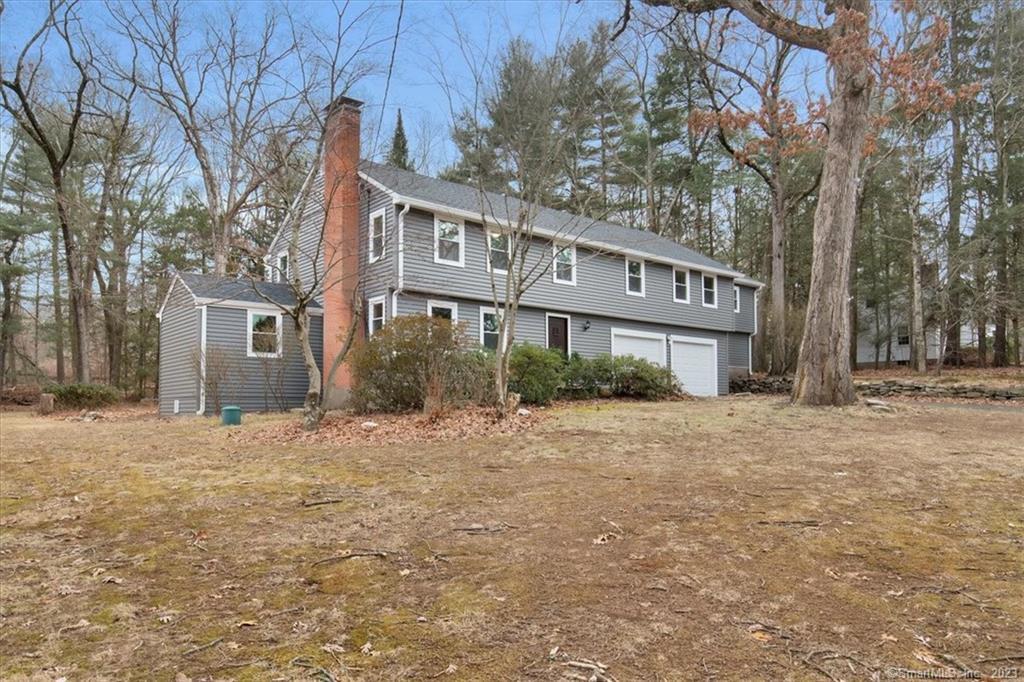 26 Williams Road Bolton, CT 06043 - Photo 1 of 1 a front view of a house with a yard and garage