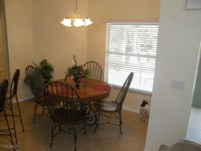 a view of a dining room with furniture and a chandelier