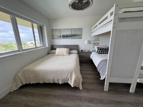 a bedroom with a bed and a large window
