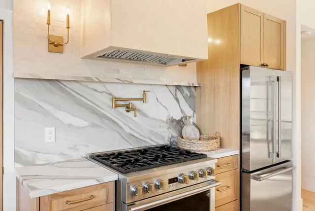 a kitchen with a stove and a refrigerator