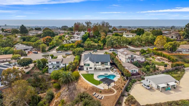 an aerial view of residential houses with outdoor space