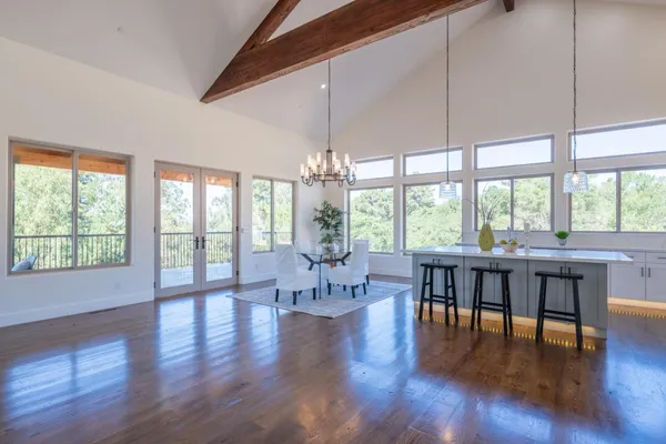a kitchen with stainless steel appliances granite countertop a stove refrigerator and wooden floor