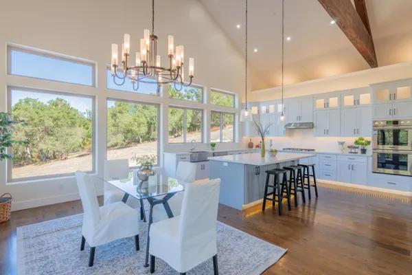 a view of a dining room with furniture wooden floor and chandelier