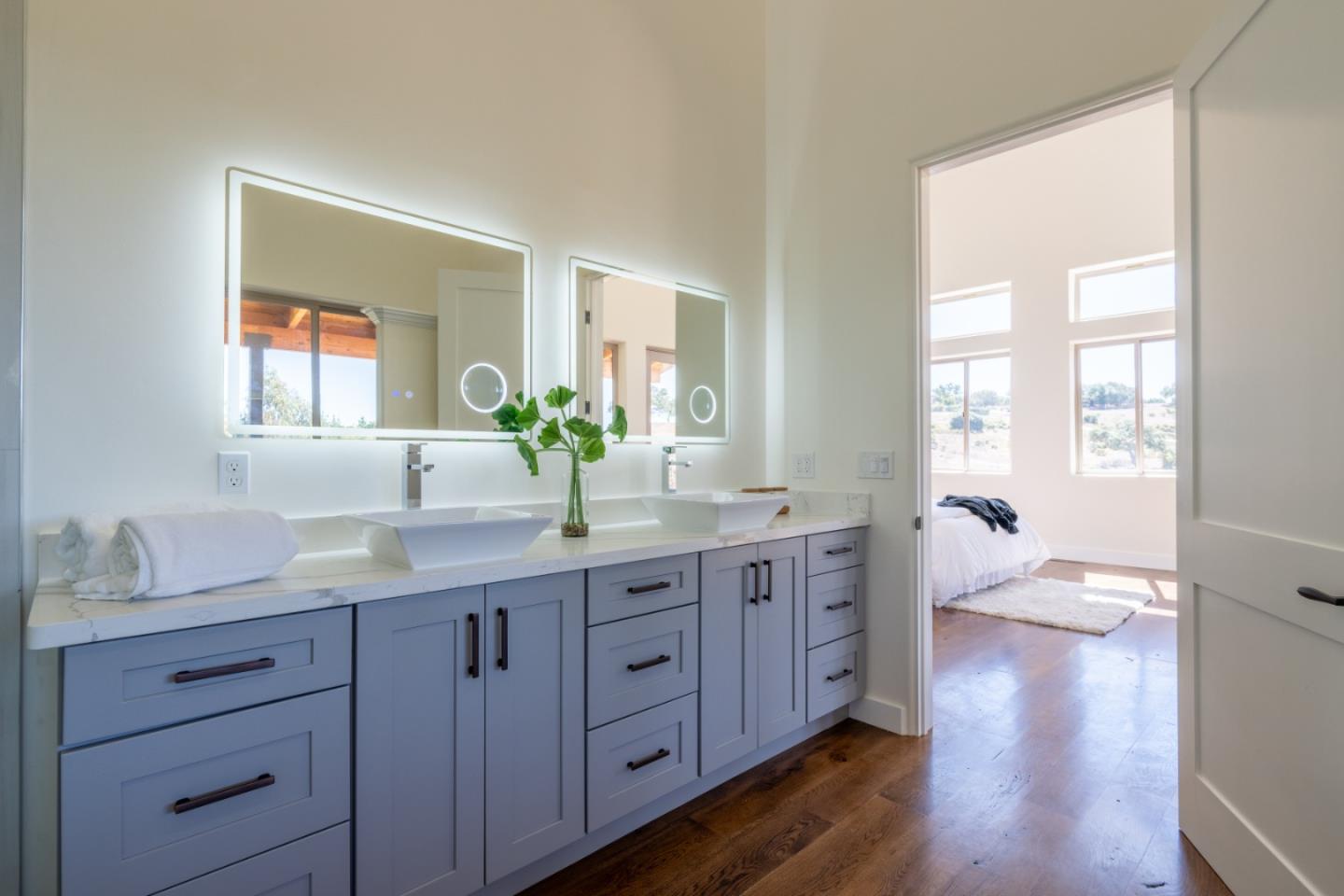 9020 Hidden Canyon Road Salinas, CA 93907 - Photo 43 of 58 a spacious bathroom with a granite countertop double vanity sink a mirror and a next to a window